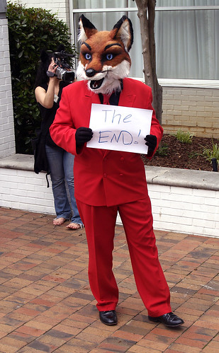 Camstone Fox holding up a sign that says "The End"